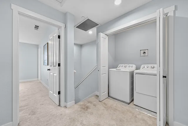 a view of a storage & utility room with a washer dryer