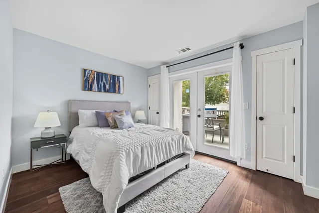 a bedroom with a large bed and a window