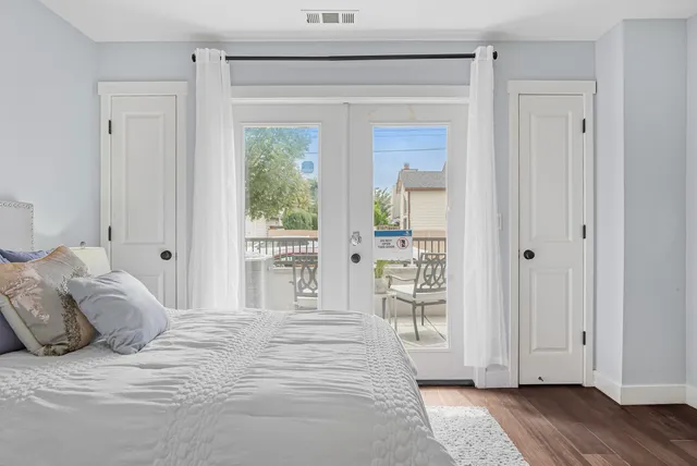 a bedroom with a large bed and a window