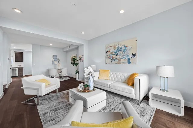 a living room with furniture and wooden floor