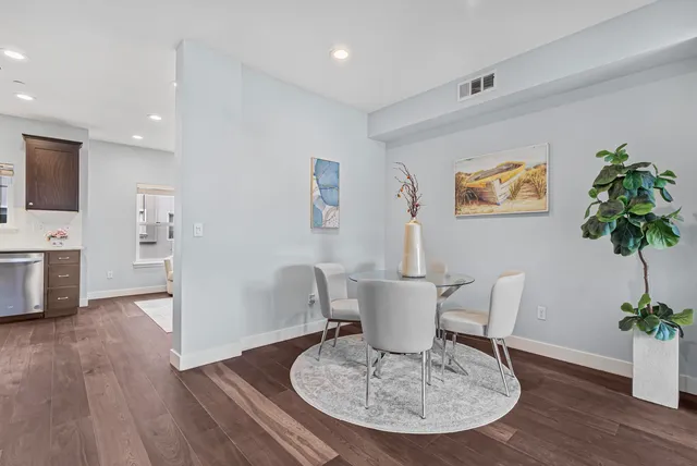 a view of a dining room with furniture and wooden floor