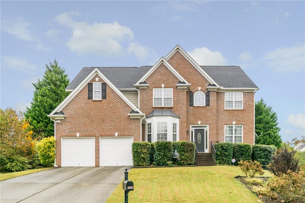 a front view of a house with a yard and garage