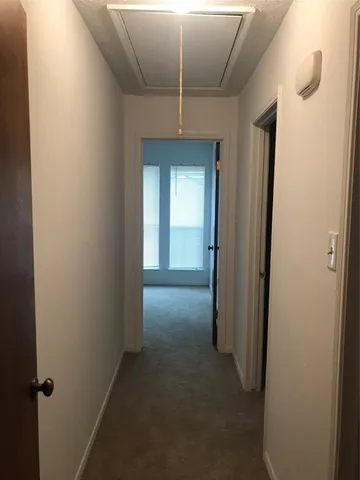 a view of a hallway to closet area