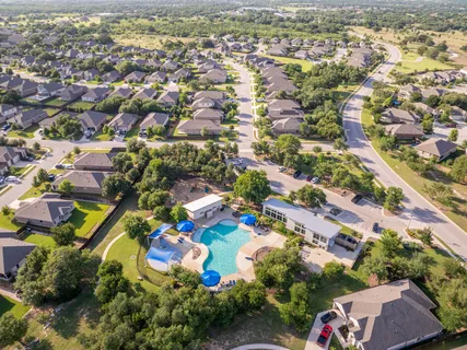 an aerial view of residential houses with outdoor space