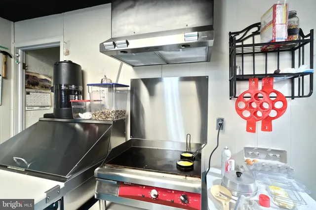 a kitchen with a refrigerator and a table