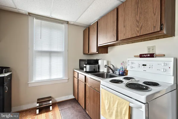 a living room with furniture a flat screen tv and large window
