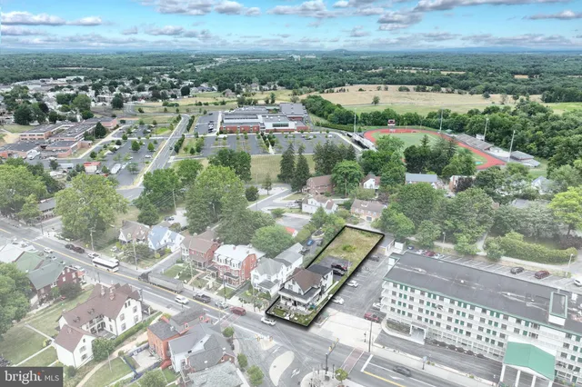 a street sign on a wall next to a road