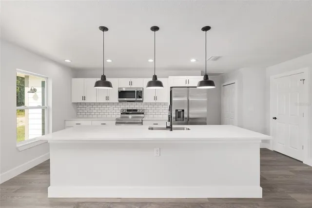 a large kitchen with stainless steel appliances