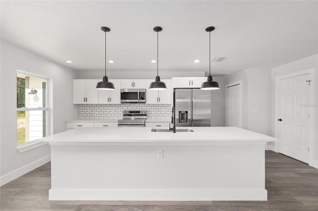 15769 Southwest 14th Street Ocala, FL 34481 - Photo 13 of 46 a large kitchen with stainless steel appliances