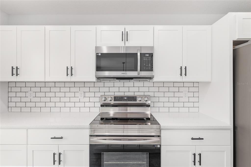 15769 Southwest 14th Street Ocala, FL 34481 - Photo 16 of 46 a kitchen with granite countertop a stove sink and microwave