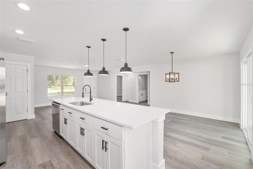 15769 Southwest 14th Street Ocala, FL 34481 - Photo 17 of 46 a kitchen with a sink and a wooden floor