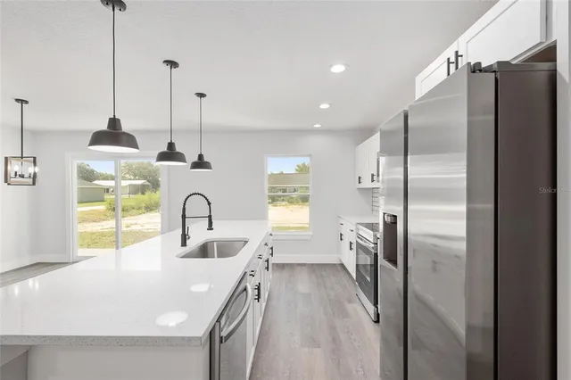 a kitchen with refrigerator a sink and dishwasher