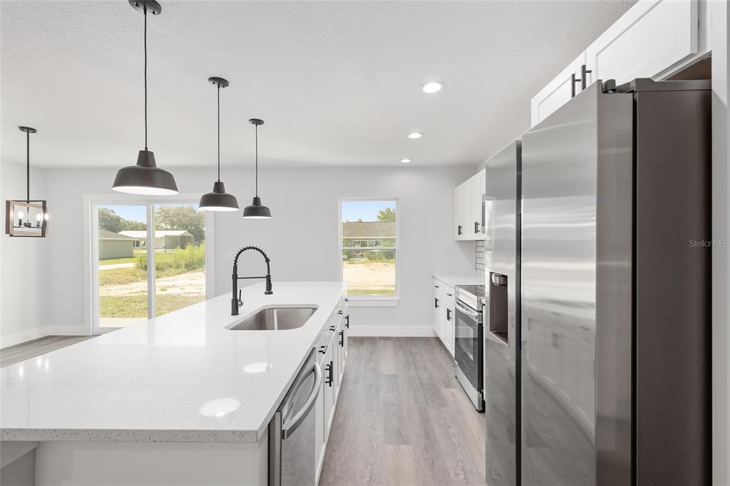15769 Southwest 14th Street Ocala, FL 34481 - Photo 21 of 46 a kitchen with refrigerator a sink and dishwasher