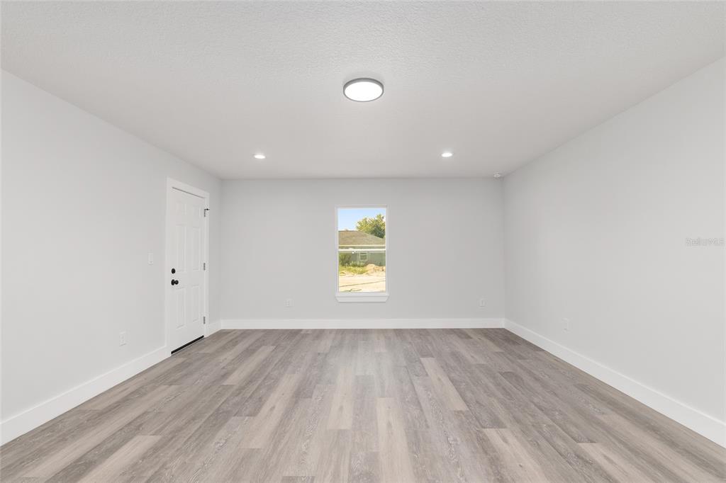 15769 Southwest 14th Street Ocala, FL 34481 - Photo 23 of 46 wooden floor in an empty room with a window