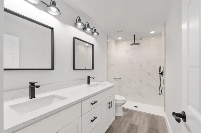 a bathroom with a double vanity sink mirror double and shower