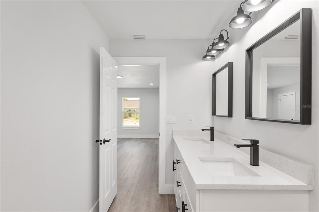 15769 Southwest 14th Street Ocala, FL 34481 - Photo 28 of 46 a bathroom with a sink vanity and mirror