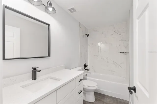 a bathroom with a sink a toilet and a bathtub