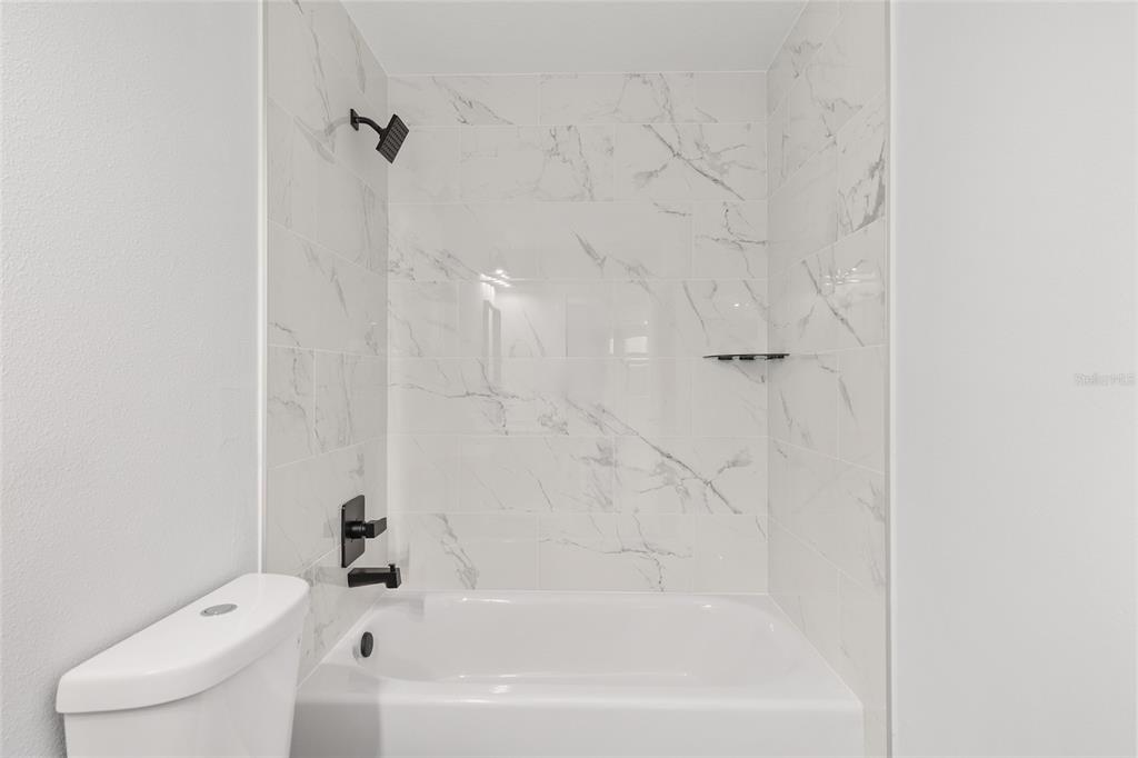 15769 Southwest 14th Street Ocala, FL 34481 - Photo 38 of 46 a bath tub sitting next to a white toilet