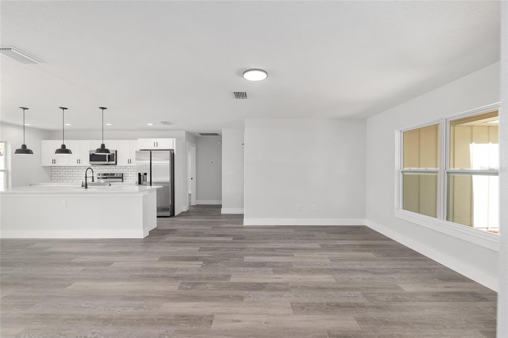 15769 Southwest 14th Street Ocala, FL 34481 - Photo 5 of 46 a view of a kitchen cabinets and wooden floor