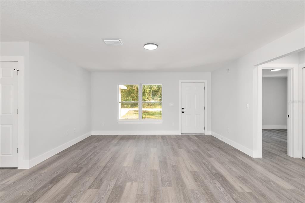 15769 Southwest 14th Street Ocala, FL 34481 - Photo 6 of 46 an empty room with wooden floor and windows