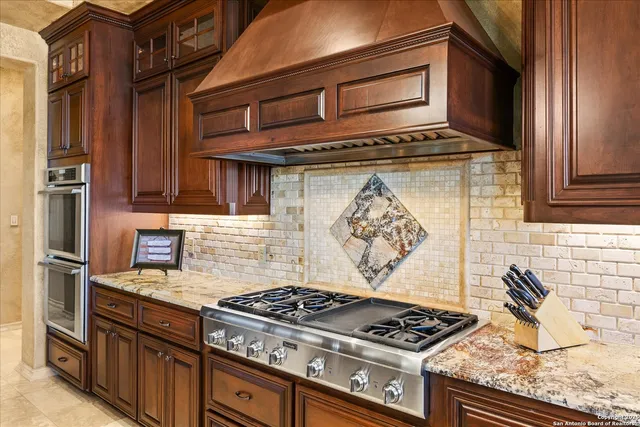a living room with furniture a fireplace and a floor to ceiling window