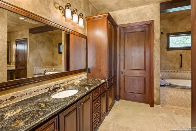 a bedroom with a bed and a flat tv screen on dresser