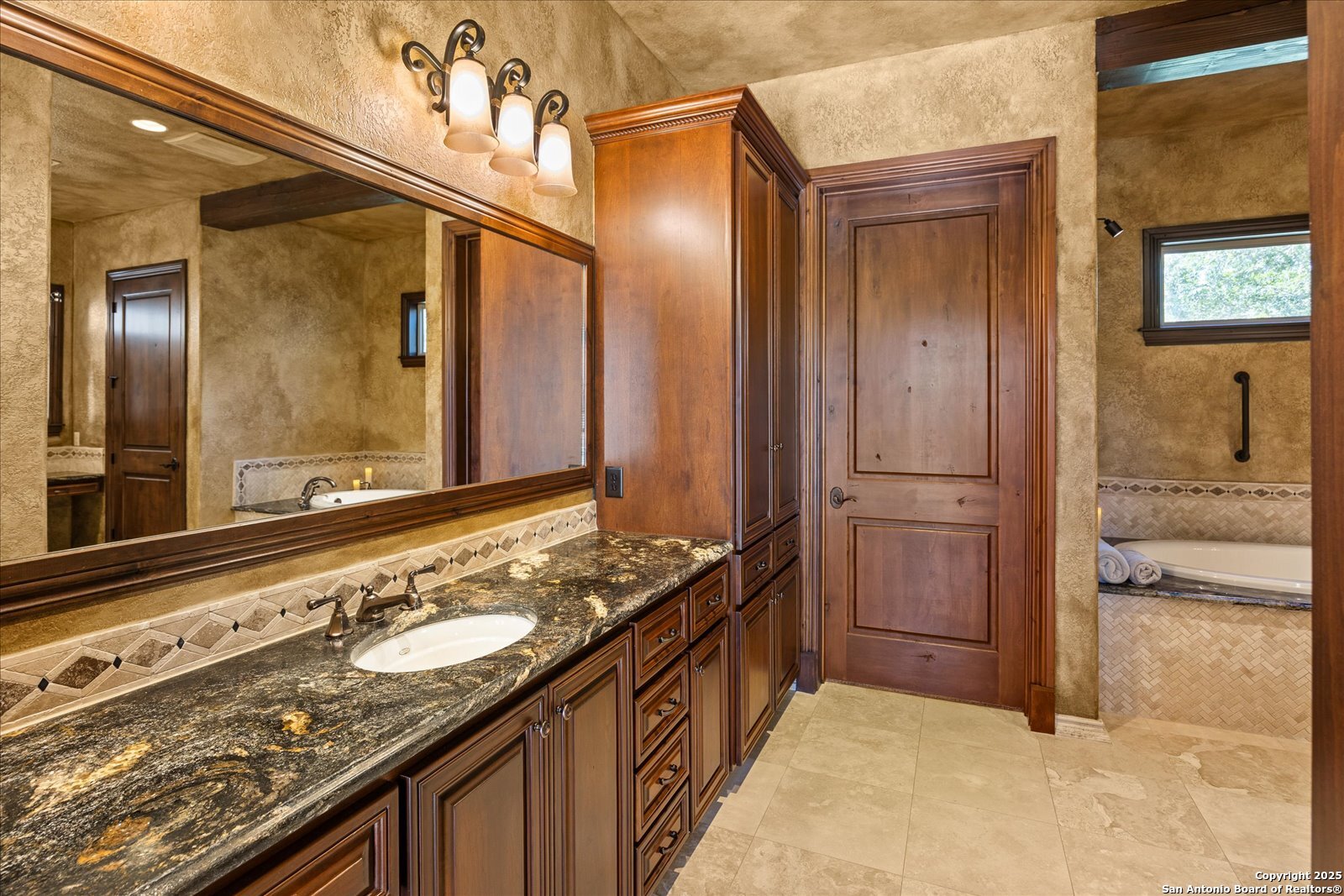 210 Rio Cordillera Boerne, TX 78006 - Photo 35 of 78 a bathroom with a granite countertop sink and a mirror