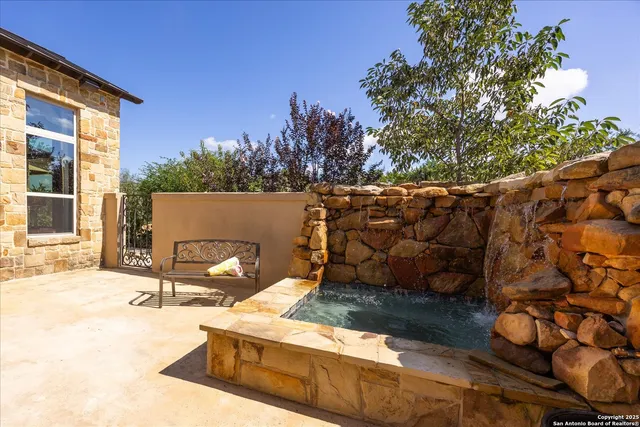 a backyard of a house with table and chairs