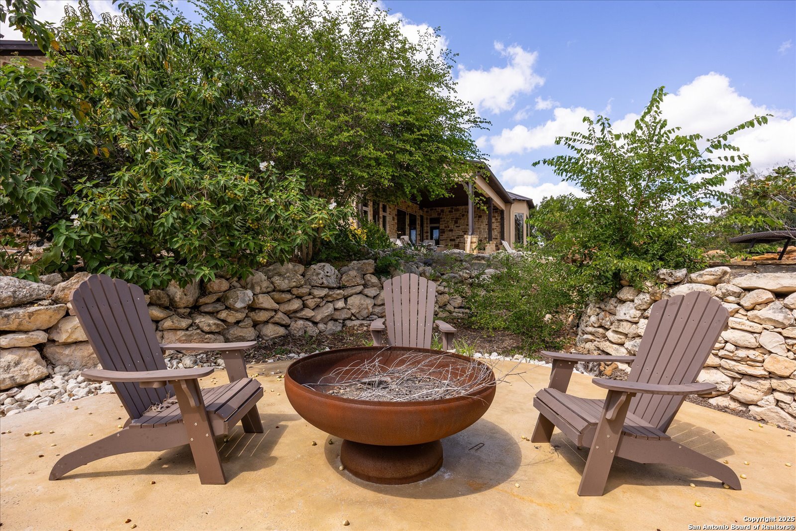 210 Rio Cordillera Boerne, TX 78006 - Photo 65 of 78 a view of a chairs and table in backyard