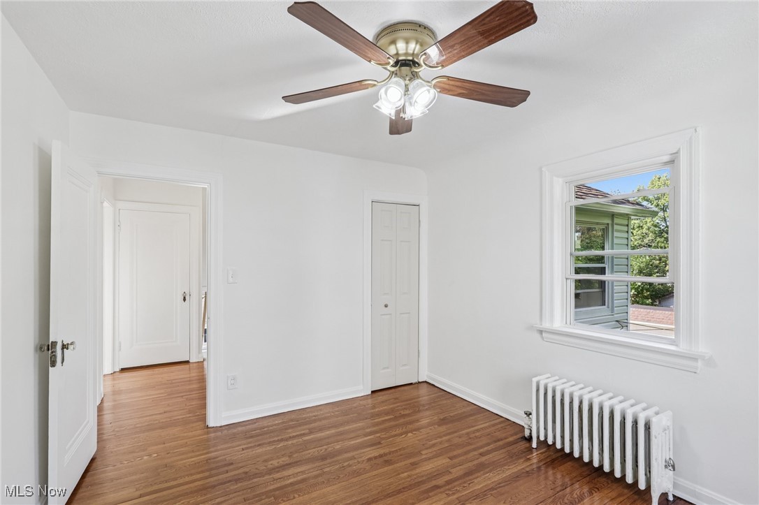 3621 Cedarbrook Road Cleveland, OH 44118 - Photo 27 of 40 Empty room featuring radiator and dark wood finished floors