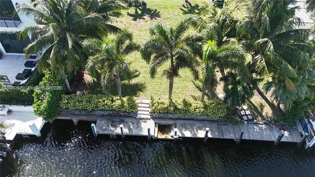 a view of house next to a yard with wooden fence