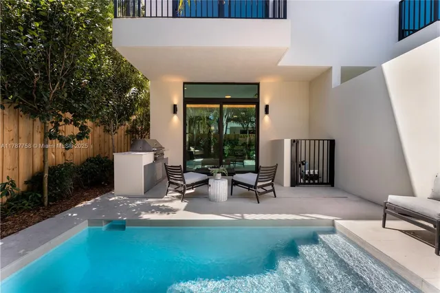 a view of a swimming pool with furniture