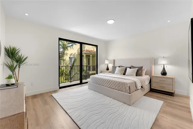 a bedroom with a large bed and a large window