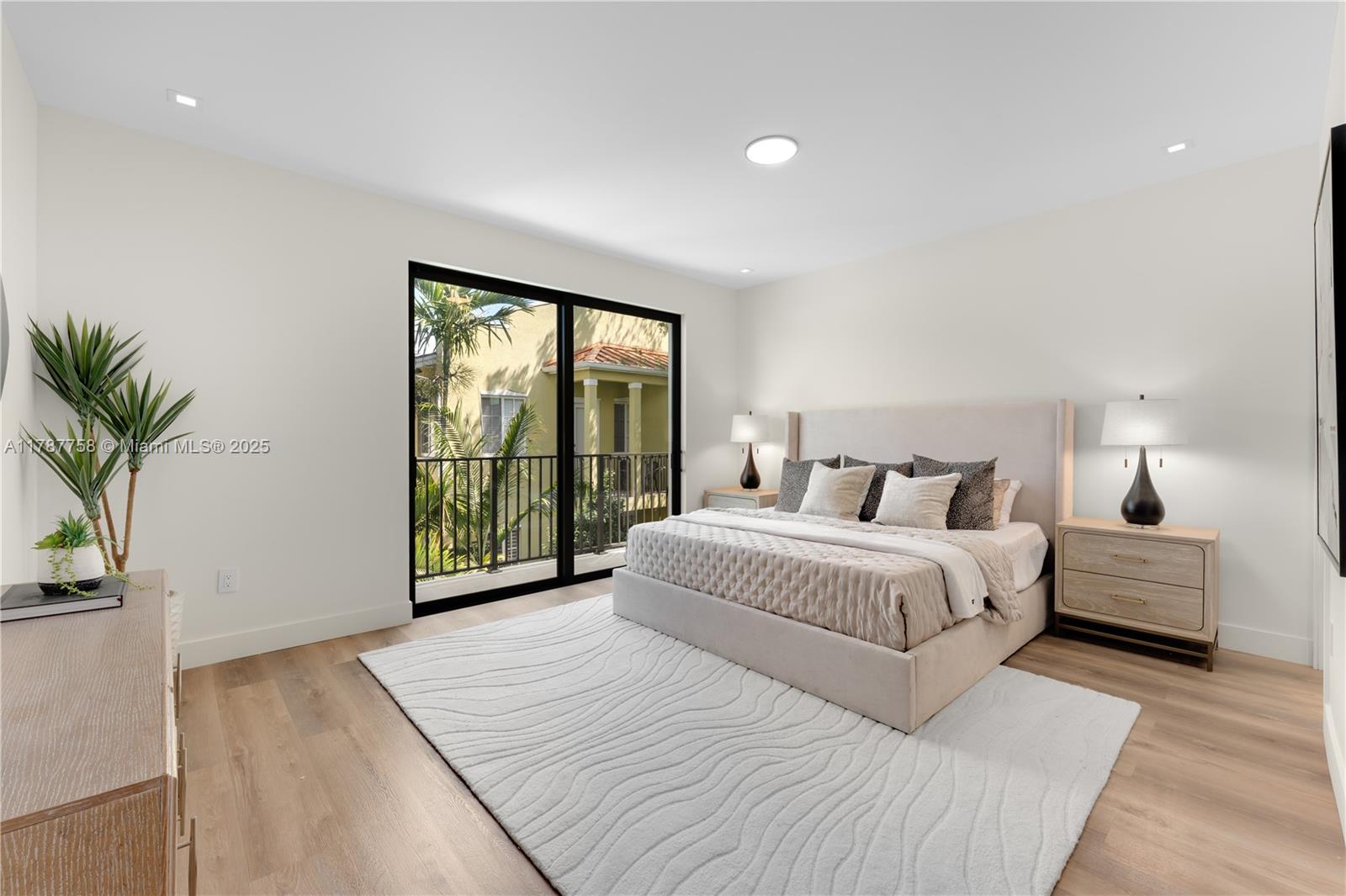 3073 Hibiscus Street, Unit 1 Miami, FL 33133 - Photo 14 of 27 a bedroom with a large bed and a large window