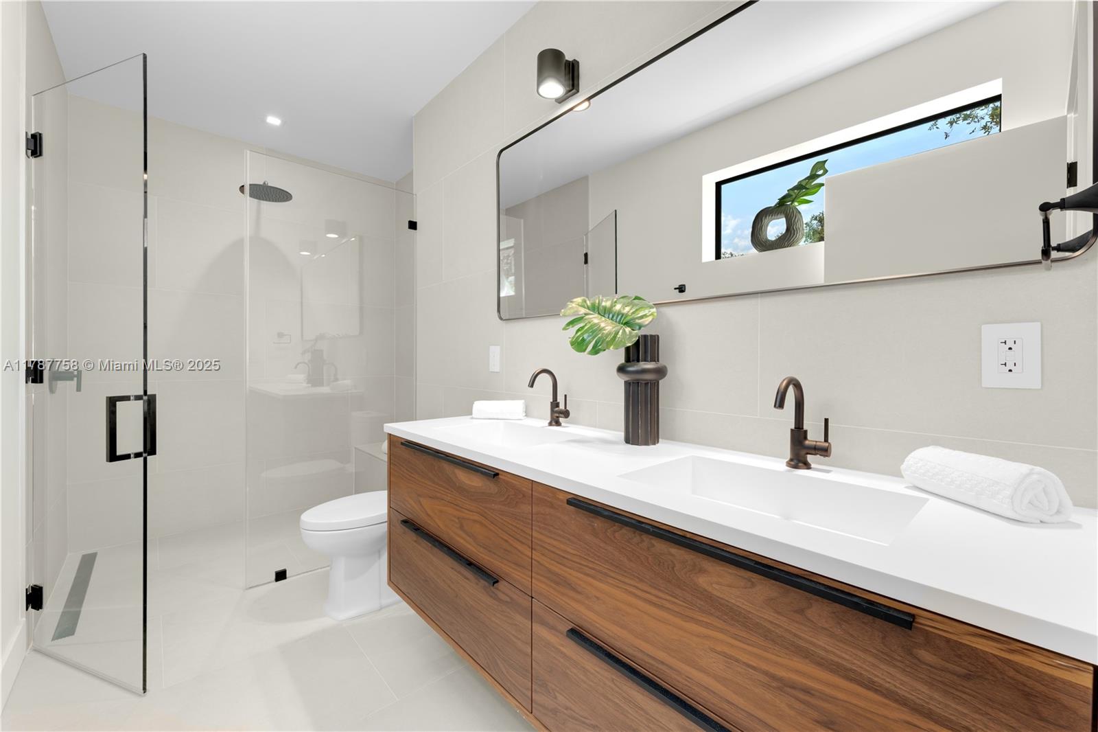 3073 Hibiscus Street, Unit 1 Miami, FL 33133 - Photo 17 of 27 a bathroom with a granite countertop sink a toilet and shower