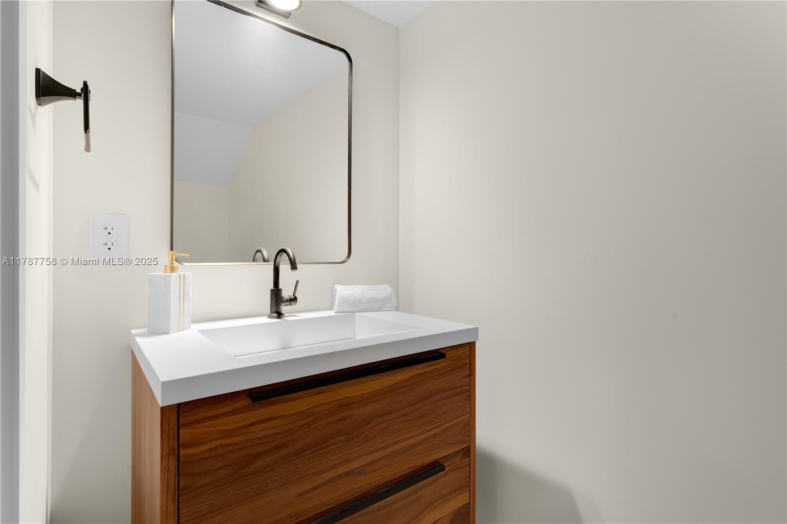 3073 Hibiscus Street, Unit 1 Miami, FL 33133 - Photo 20 of 27 a close up of a sink and a mirror