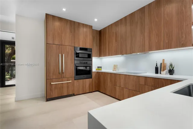 a kitchen with refrigerator and cabinets