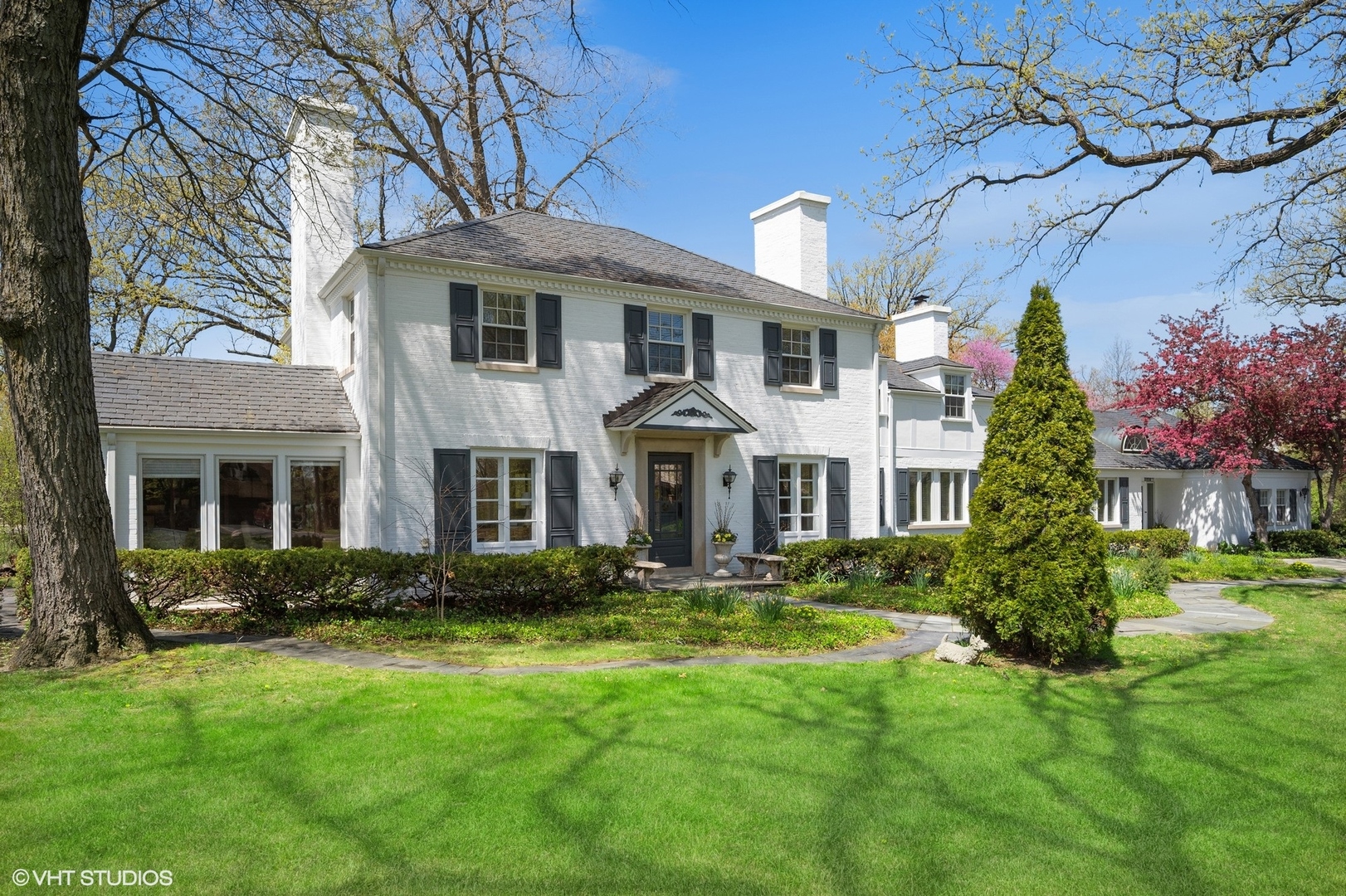 1744 Ridgewood Lane East Glenview, IL 60025 - Photo 1 of 48 a front view of a house with a yard