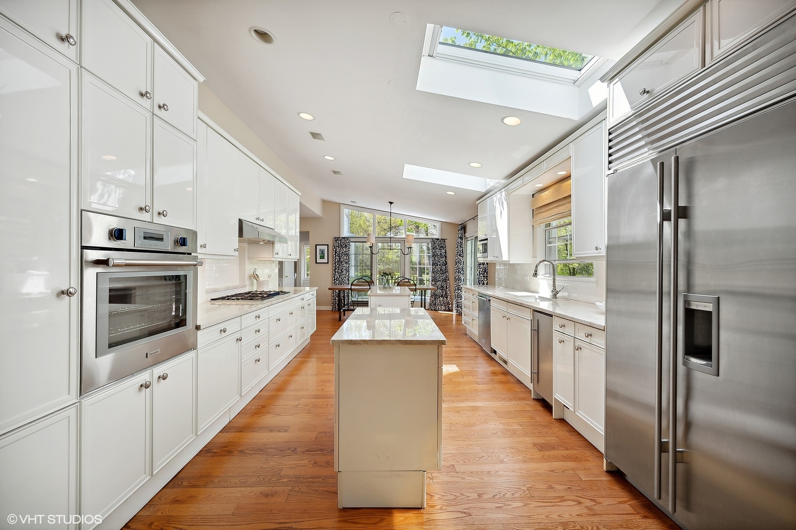 1744 Ridgewood Lane East Glenview, IL 60025 - Photo 14 of 48 a large white kitchen with stainless steel appliances
