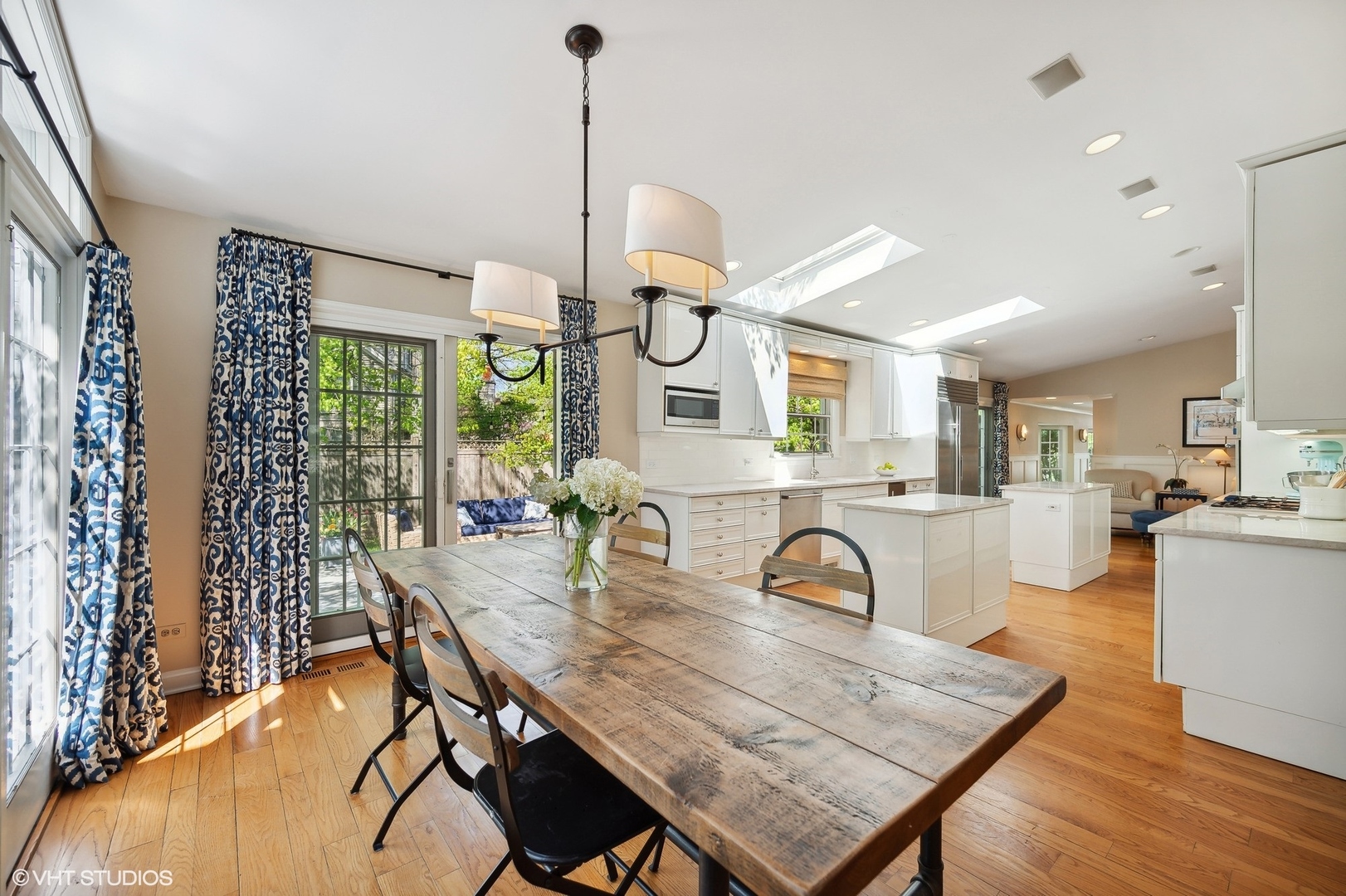 1744 Ridgewood Lane East Glenview, IL 60025 - Photo 19 of 48 a view of a dining room and livingroom with furniture wooden floor a chandelier