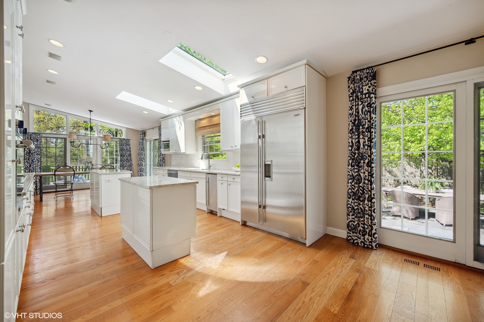 1744 Ridgewood Lane East Glenview, IL 60025 - Photo 23 of 48 a open kitchen with white cabinets and wooden floor
