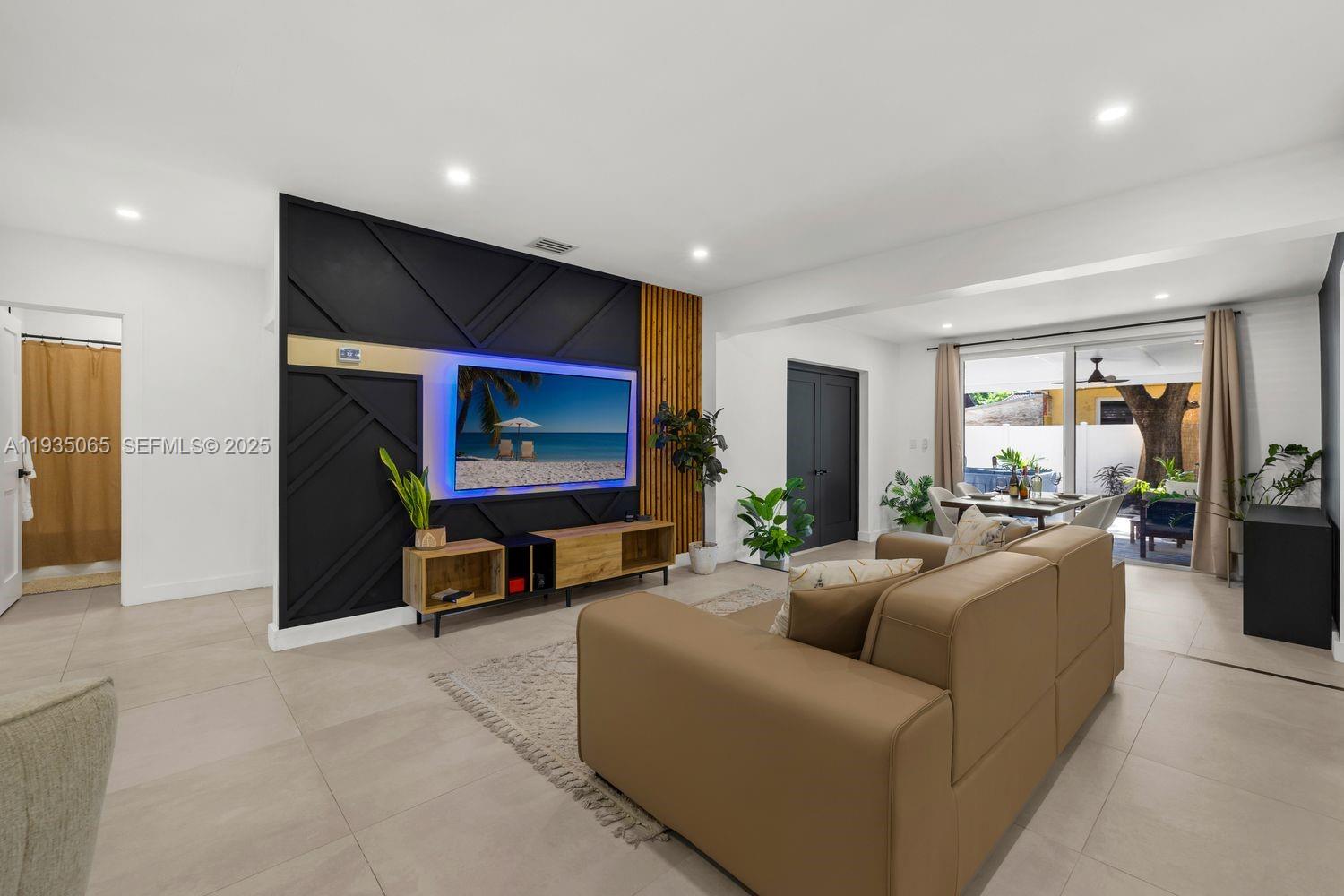 3260 Northwest 9th Street Miami, FL 33125 - Photo 13 of 33 a living room with furniture and a flat screen tv