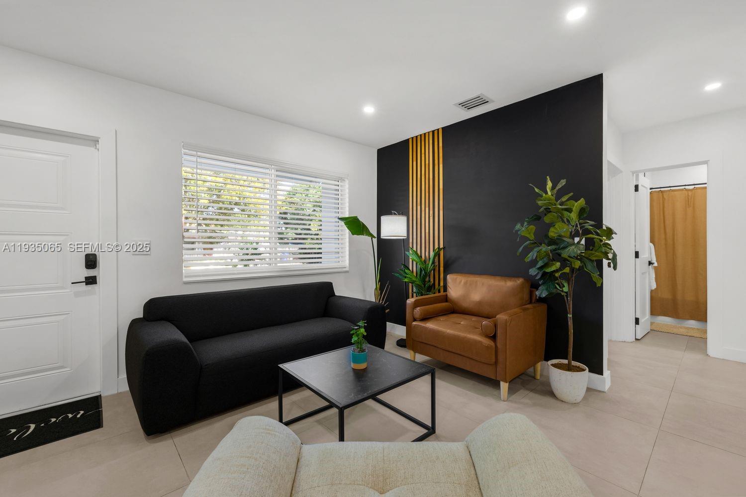 3260 Northwest 9th Street Miami, FL 33125 - Photo 18 of 33 a living room with furniture and a potted plant
