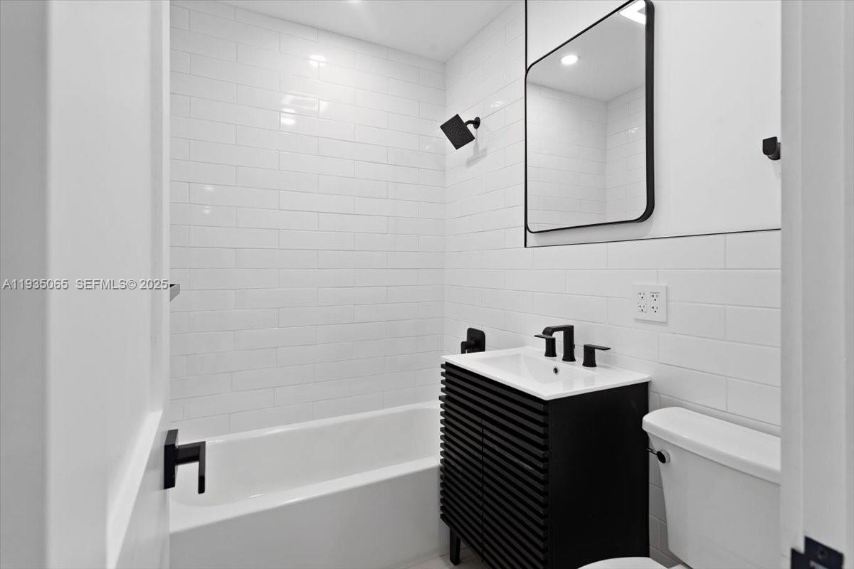 3260 Northwest 9th Street Miami, FL 33125 - Photo 19 of 33 a bathroom with a sink a toilet and shower