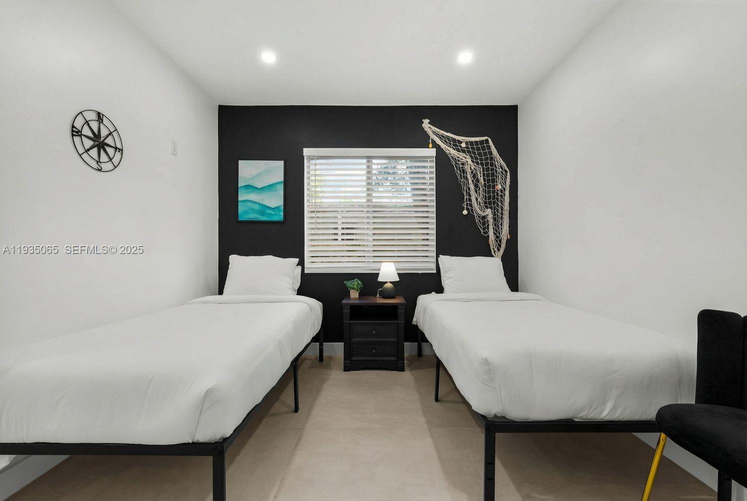 3260 Northwest 9th Street Miami, FL 33125 - Photo 20 of 33 a bedroom with a bed and a table