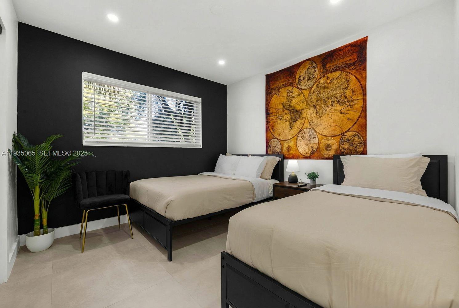 3260 Northwest 9th Street Miami, FL 33125 - Photo 21 of 33 a bedroom with two beds and a potted plant