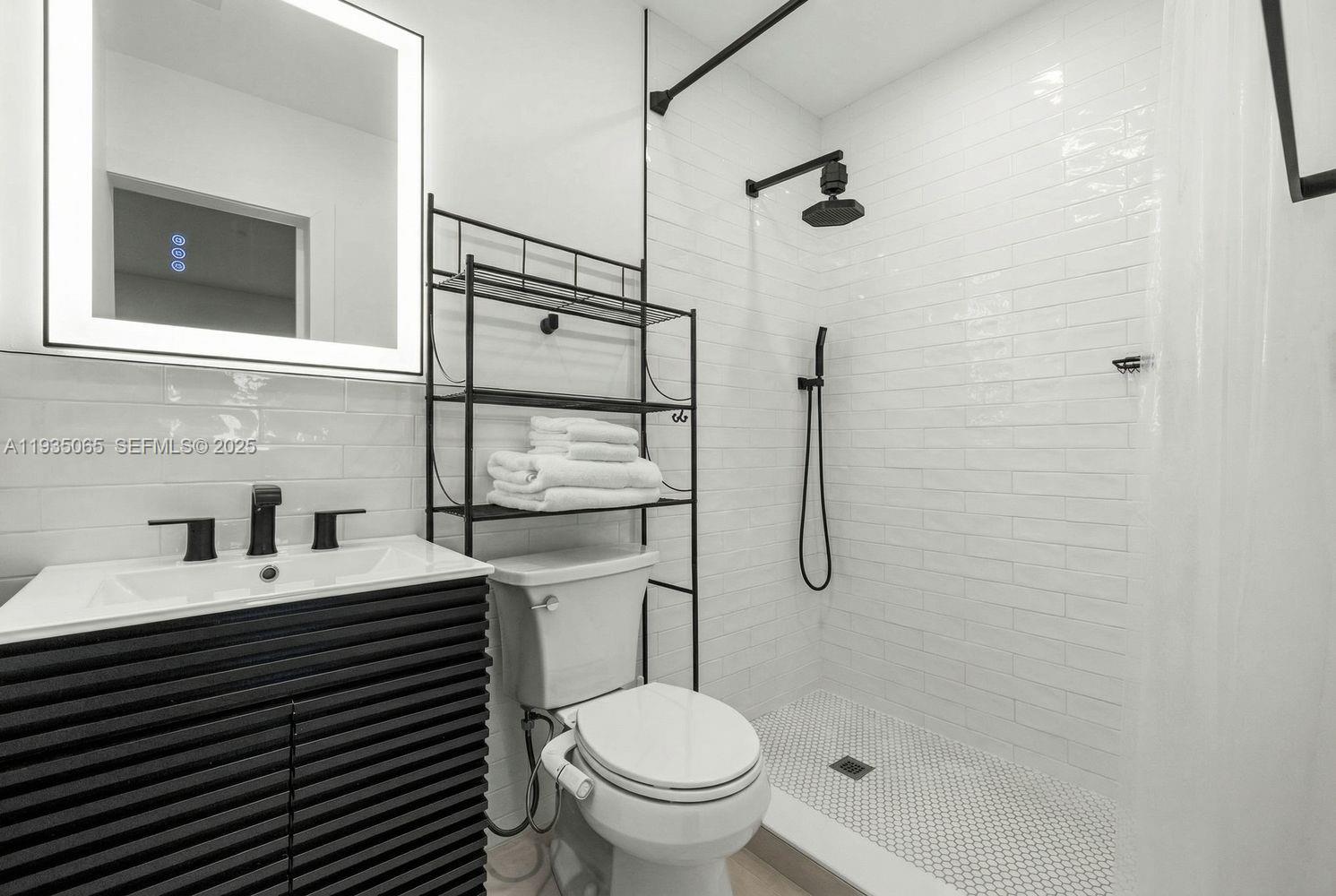 3260 Northwest 9th Street Miami, FL 33125 - Photo 26 of 33 a bathroom with a sink toilet and shower