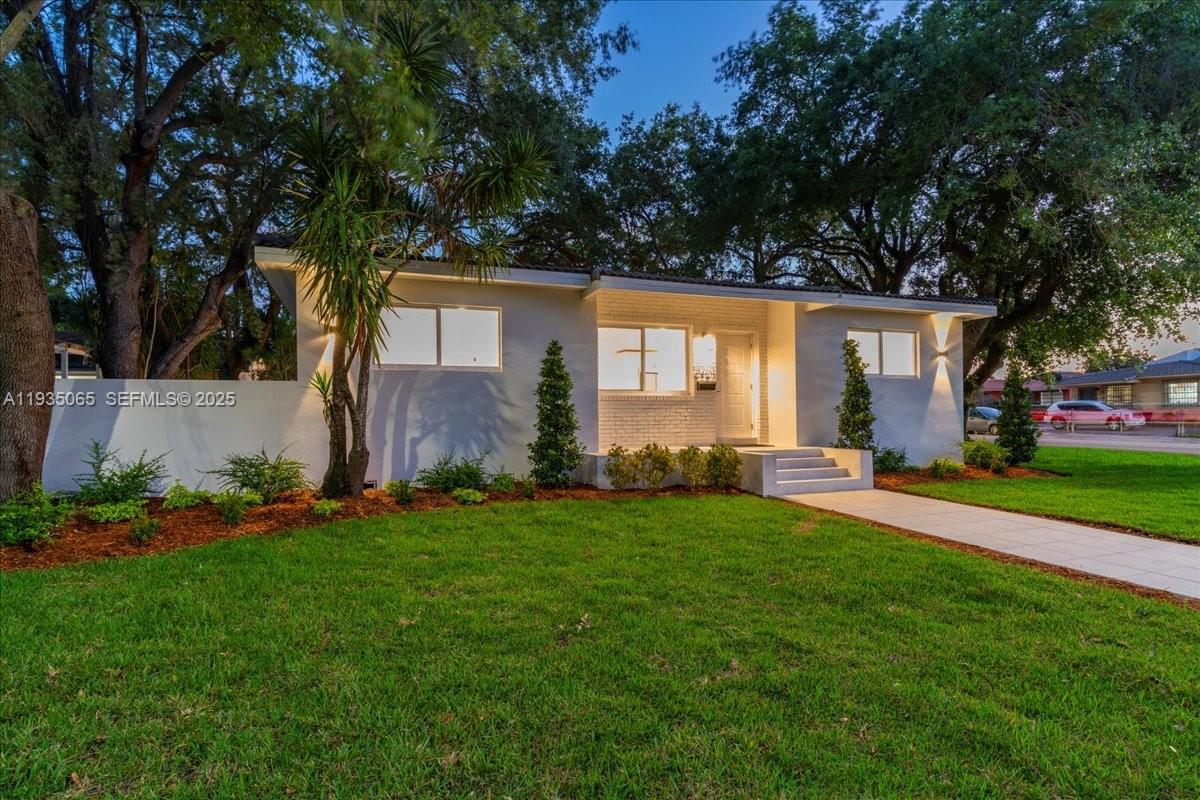 3260 Northwest 9th Street Miami, FL 33125 - Photo 3 of 33 front view of a house with a yard