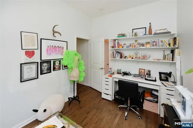 a view of a workspace with furniture and wooden floor