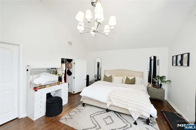 a bedroom with a bed and a chandelier